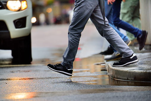 pedestrian stepping into the street as an SUV approaches the crosswalk