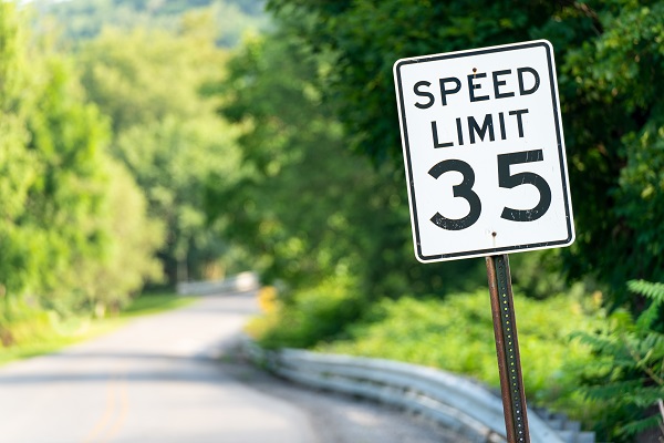 A 35 mph speed limit sign on a winding New Hampshire road.